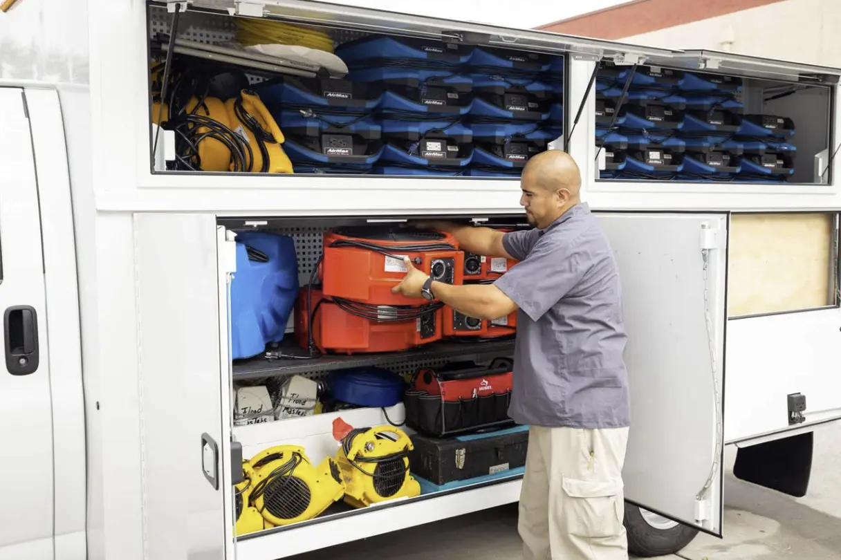 industrial air movers drying a room
